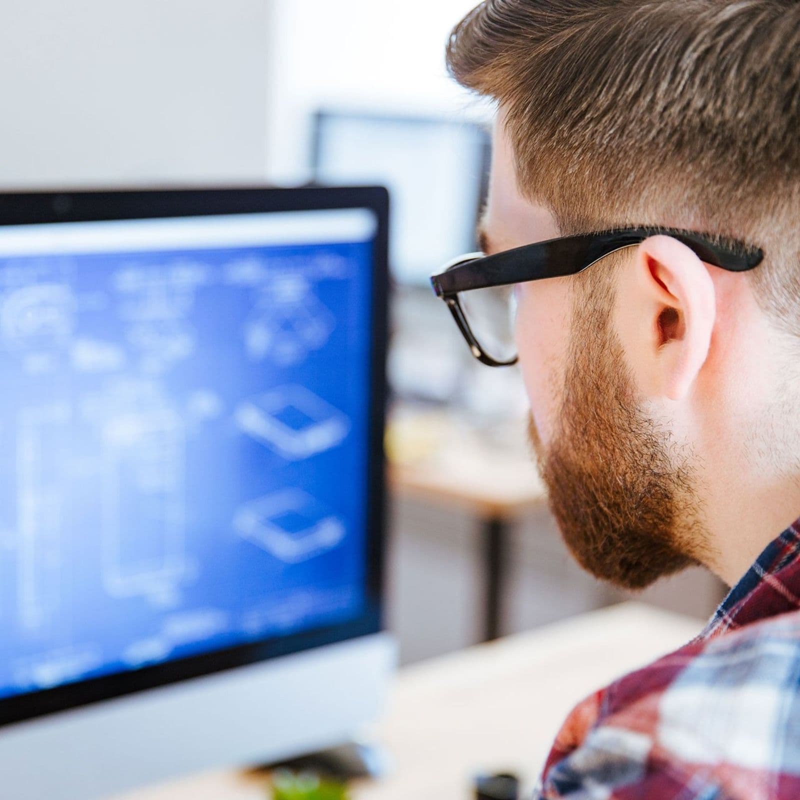A developer reviewing a system schematic on screen.